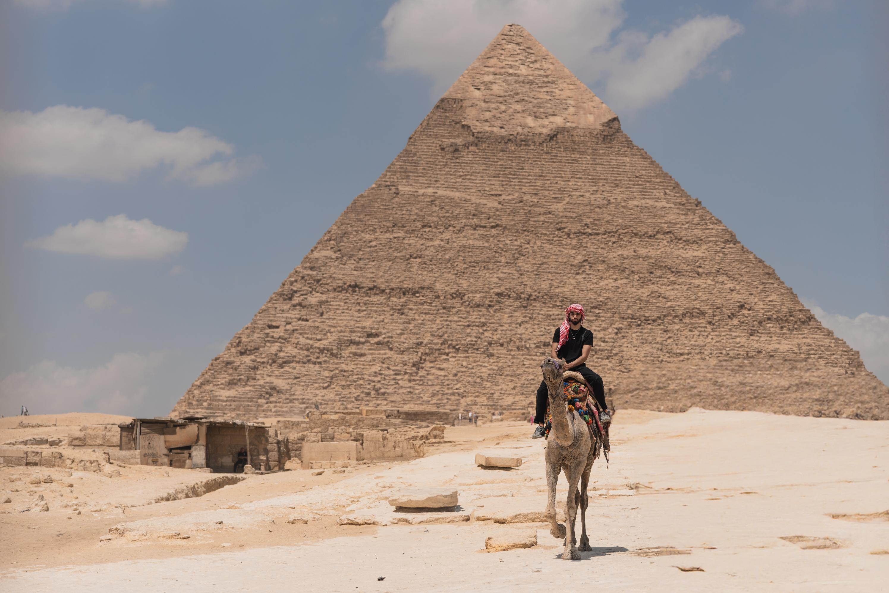 tourist-riding-a-camel-near-pyramid